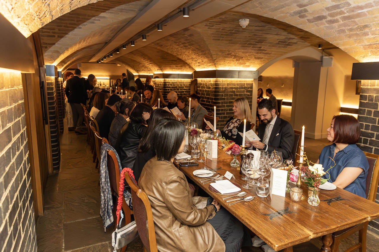 Guests gathered for dinner in the Berry Bros. & Rudd wine cellar